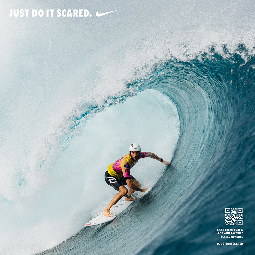 image of man surfing in tunnel blue wave with the text just do it scared written in the corner